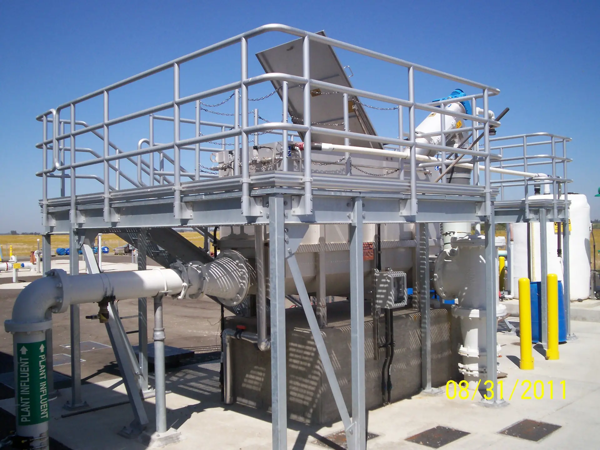 Steel maintenance platform wrapping around process equipment.